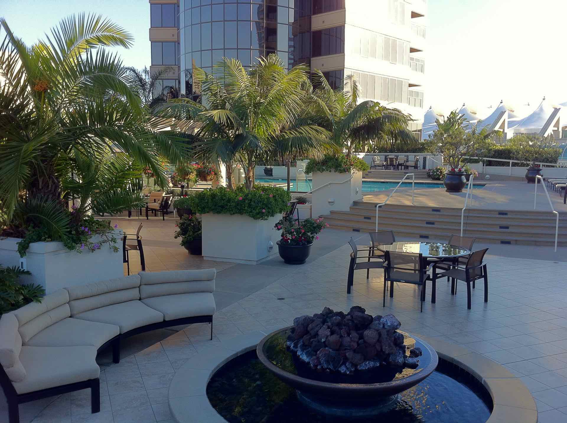 pool deck and seating area with a fire pit at Harbor Club Towers in San Diego
