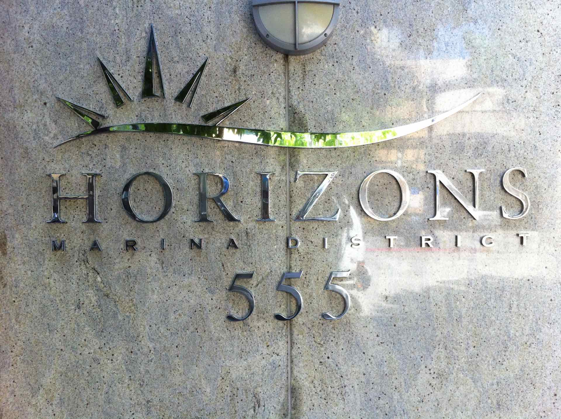 Building sign that says 'Horizons Marina District'