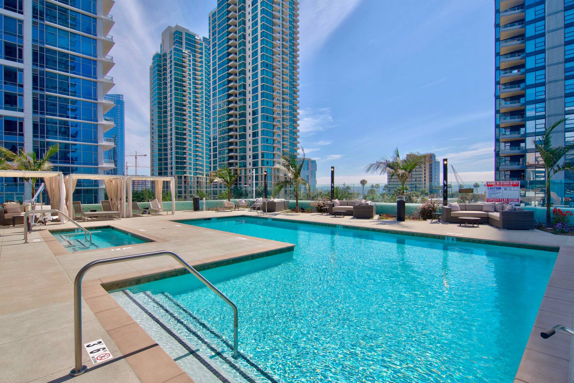 Pool deck features cabanas, a fire pit and spa