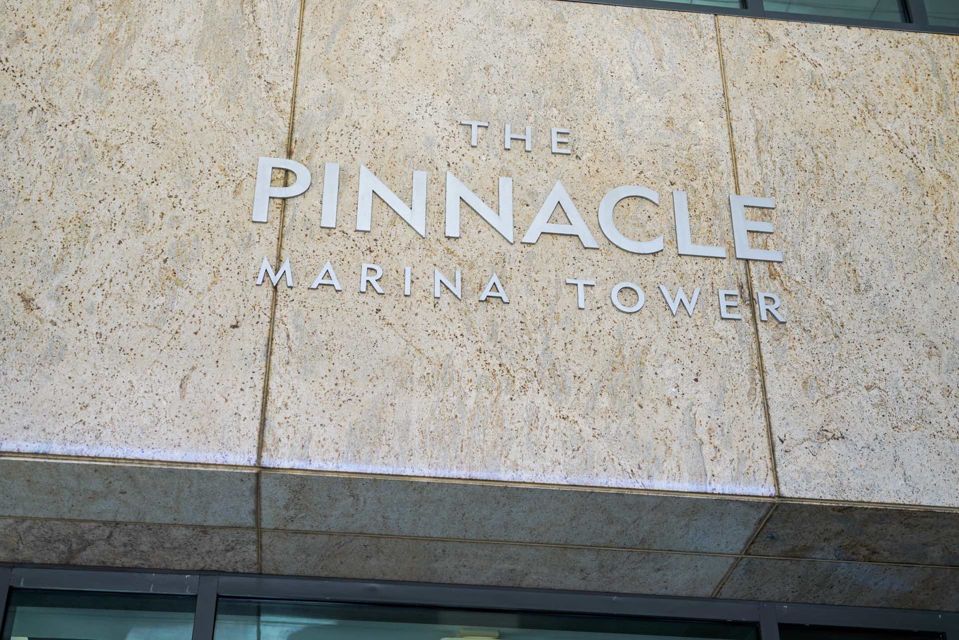 Building sign that reads "the pinnacle marina tower"